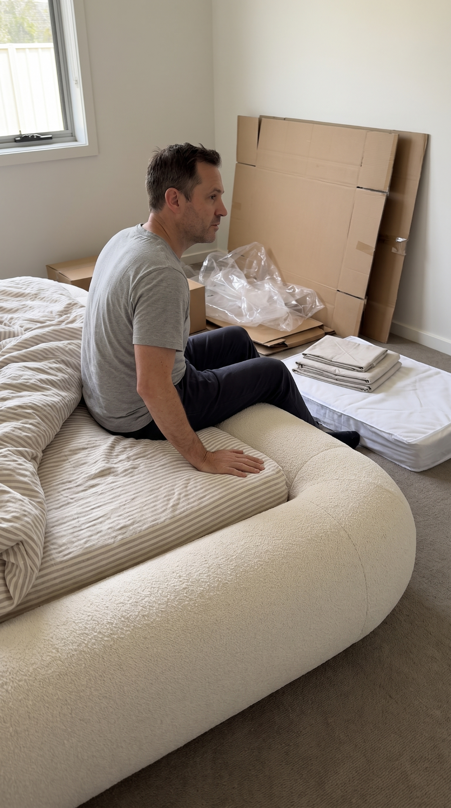 Customer photo during setup of an off white VELAR bed with packaging in the bedroom