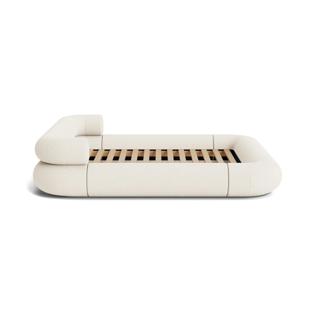 VELAR Sculptural Bed Frame in off white, side profile showing low sculptural upholstered form and timber slats