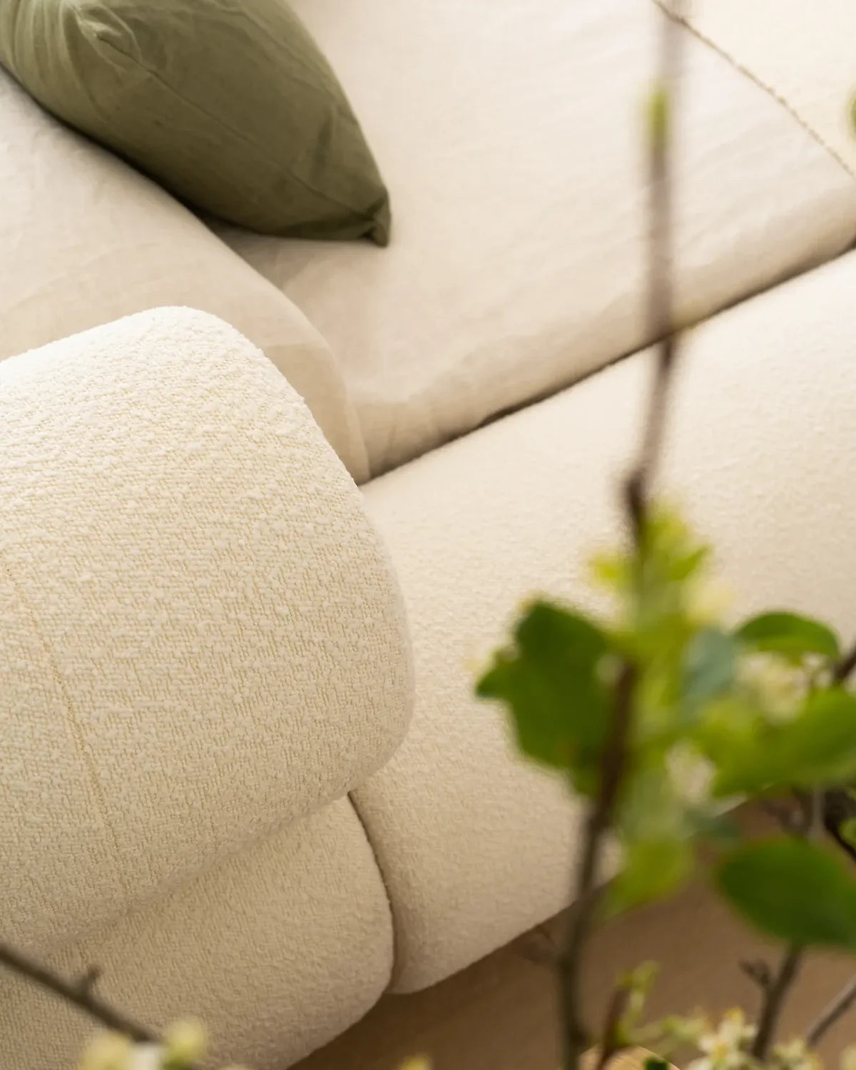 VELAR Sculptural Bed Frame in off white, close-up of soft upholstered bolster and curved frame detail